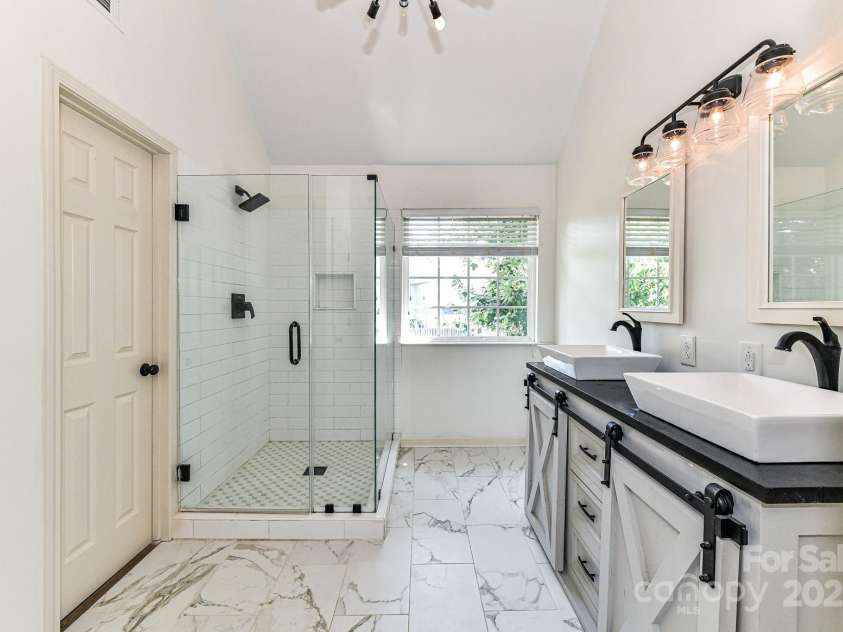 112 Denham Place, Mooresville, NC 28115.  MLS# CAR4237866, YatesRealty ID 7931. Primary Bath features dual, custom vanity, tiled shower, custom lighting, custom cabinetry & tile floors!