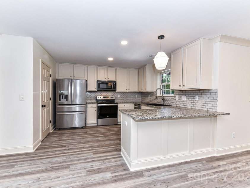 112 Denham Place, Mooresville, NC 28115.  MLS# CAR4237866, YatesRealty ID 7931. Remodeled, Upgraded Kitchen offers granite counters, stainless steel appliances, tile back splash, custom lighting, plenty of cabinetry for storage & walk in pantry!