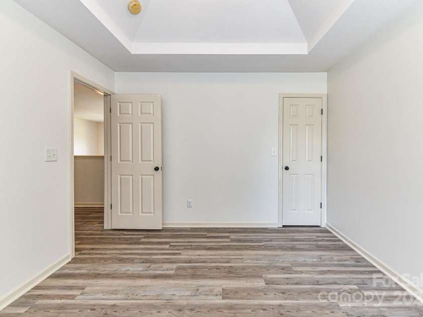 112 Denham Place, Mooresville, NC 28115.  MLS# CAR4237866, YatesRealty ID 7931. Spacious Bedroom 3 on upper level with double tray ceiling, ceiling fan/light & LVP!