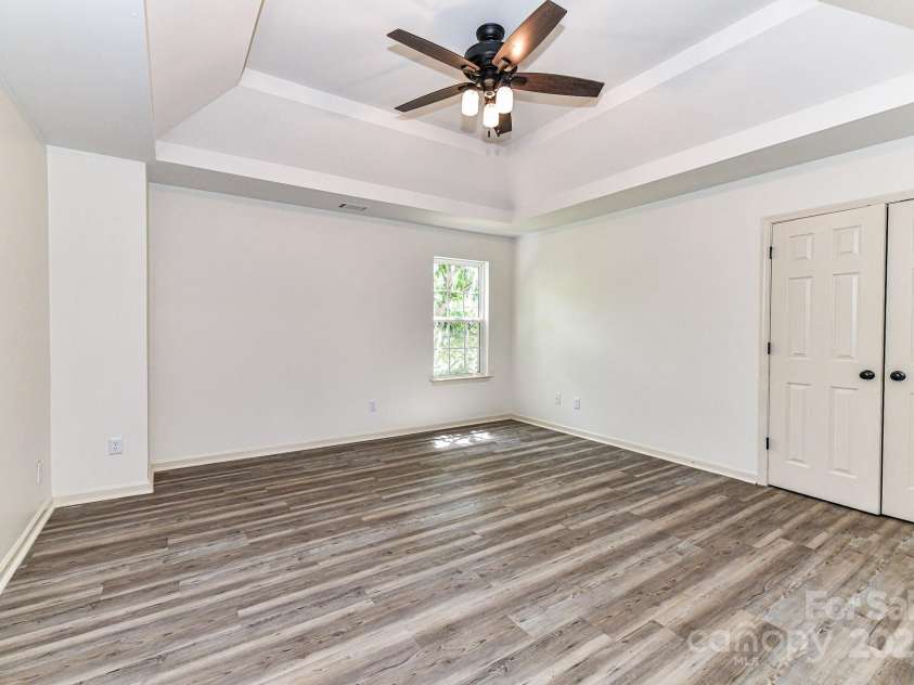 112 Denham Place, Mooresville, NC 28115.  MLS# CAR4237866, YatesRealty ID 7931. Spacious Bedroom 4 on upper level with double tray ceiling, ceiling fan/light & LVP flooring!