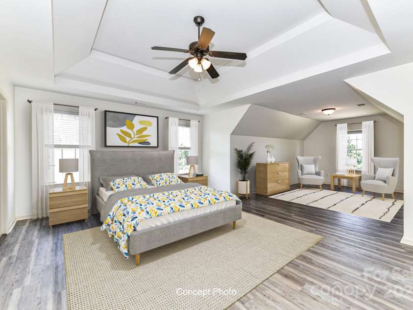 112 Denham Place, Mooresville, NC 28115.  MLS# CAR4237866, YatesRealty ID 7931. Spacious Primary Suite on upper level with double tray ceiling, ceiling fan/light, sitting area, LVP floors, private bath & walk in closet (virtually staged photo)!