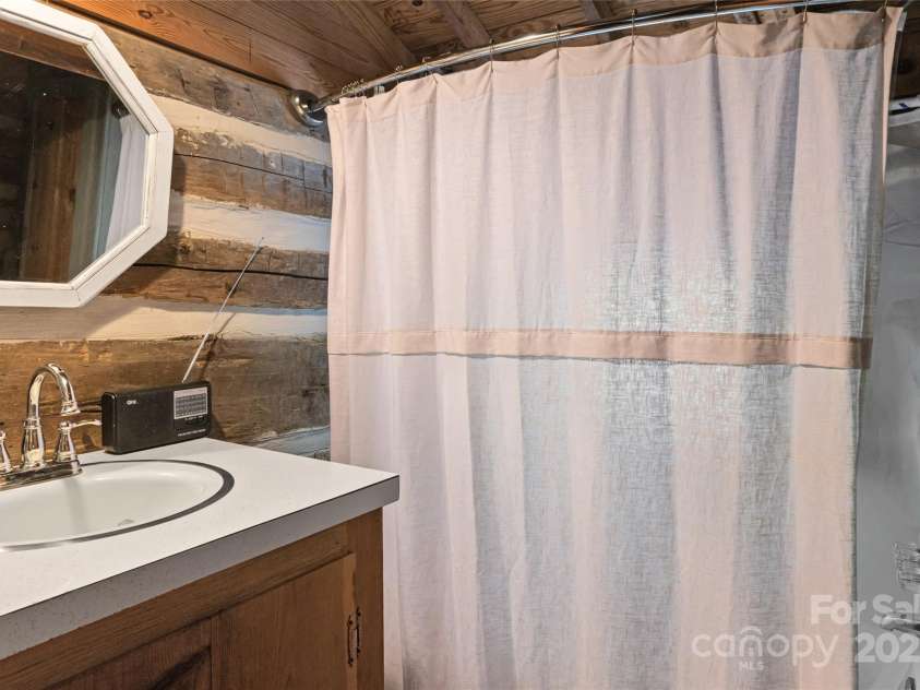 2395 Hortons Creek Road, Burnsville, NC 28714.  MLS# CAR4219244, YatesRealty ID 7959. One of two full baths - don't the old timers wish they had one!