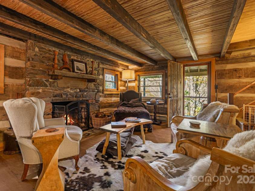 2395 Hortons Creek Road, Burnsville, NC 28714.  MLS# CAR4313609, YatesRealty ID 7959. Living room with stairs