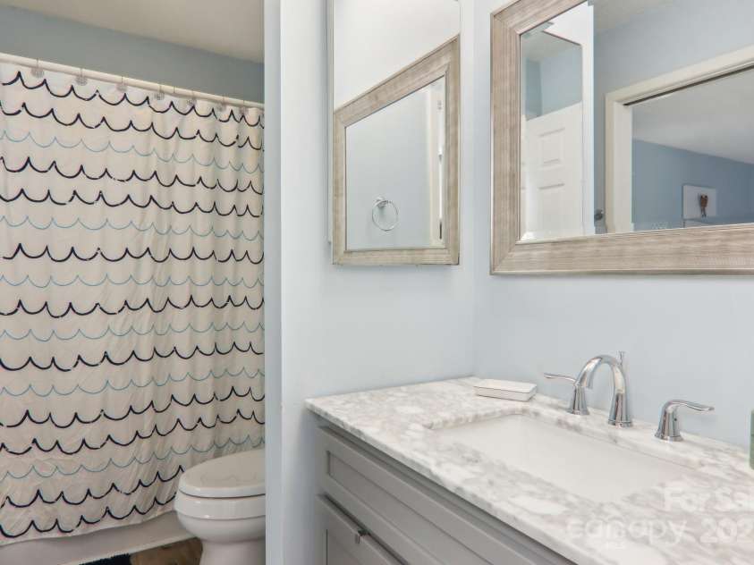 182 Lake Drive, Lake Lure, NC 28746.  MLS# CAR4170164, YatesRealty ID 7965. Updated bathroom with tub/shower combo