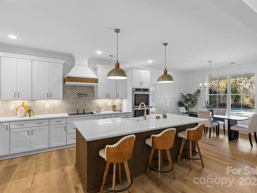 4734 Polk Ford Road, Stanfield, NC 28163.  MLS# CAR4321692, YatesRealty ID 7971. *representative photo- gourmet kitchen w/ custom wood hood vent, double oven, microwave built into the island, oversized level 3 quartz countertops, porcelain farmhouse sink
