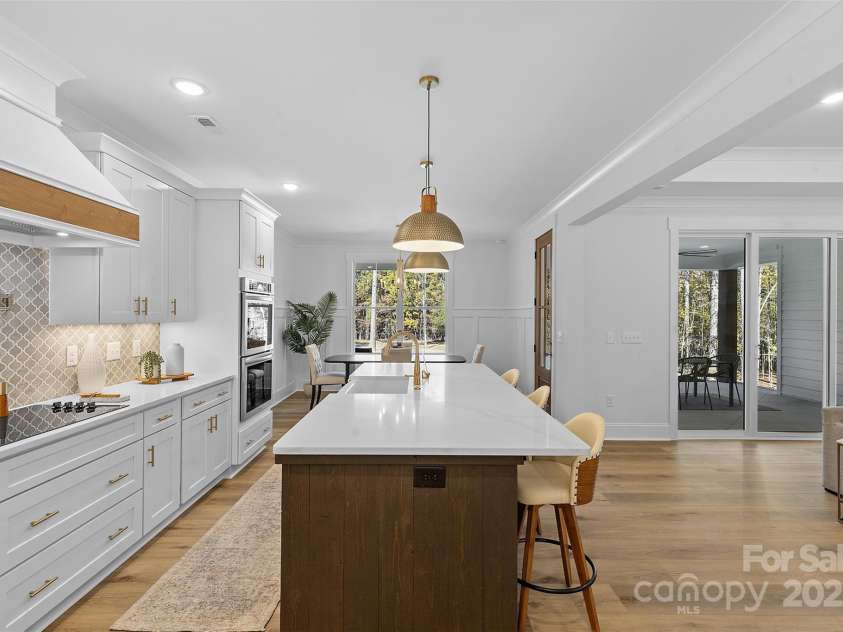 4734 Polk Ford Road, Stanfield, NC 28163.  MLS# CAR4321692, YatesRealty ID 7971. *representative photo- gourmet kitchen w/ custom wood hood vent, double oven, microwave built into the island, oversized level 3 quartz countertops, porcelain farmhouse sink