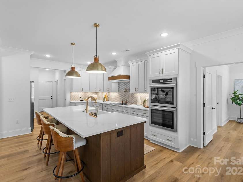 4734 Polk Ford Road, Stanfield, NC 28163.  MLS# CAR4321692, YatesRealty ID 7971. *representative photo- gourmet kitchen w/ custom wood hood vent, double oven, microwave built into the island, oversized level 3 quartz countertops, porcelain farmhouse sink
