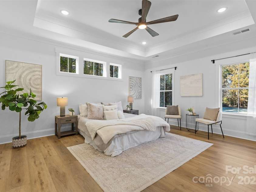 4734 Polk Ford Road, Stanfield, NC 28163.  MLS# CAR4321692, YatesRealty ID 7971. *representative photo- primary bedroom w/ tray ceiling, additional windows for natural light, ensuite bathroom, and a private access to the covered back porch!