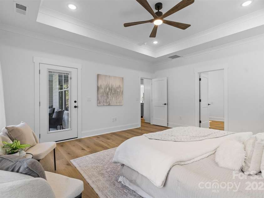 4734 Polk Ford Road, Stanfield, NC 28163.  MLS# CAR4321692, YatesRealty ID 7971. *representative photo- primary bedroom w/ tray ceiling, additional windows for natural light, ensuite bathroom, and a private access to the covered back porch!