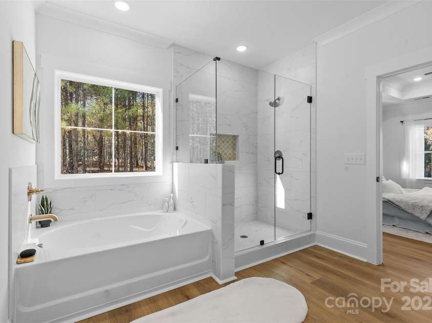 4734 Polk Ford Road, Stanfield, NC 28163.  MLS# CAR4321692, YatesRealty ID 7971. *representative photo- primary ensuite full bath w/ tub, frameless custom tiled shower, separate commode room