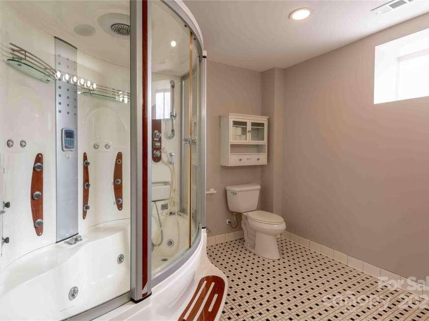 311 Buncombe Street, Hendersonville, NC 28739.  MLS# CAR4176141, YatesRealty ID 7991. Downstairs bathroom with jetted shower/tub