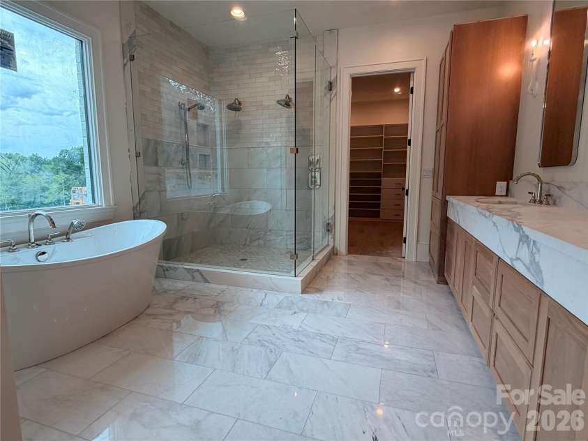 1430 Samuel Spencer Parkway, Davidson, NC 28036.  MLS# CAR4305336, YatesRealty ID 8. Primary Bath with expansive walk in shower and spacious tub.