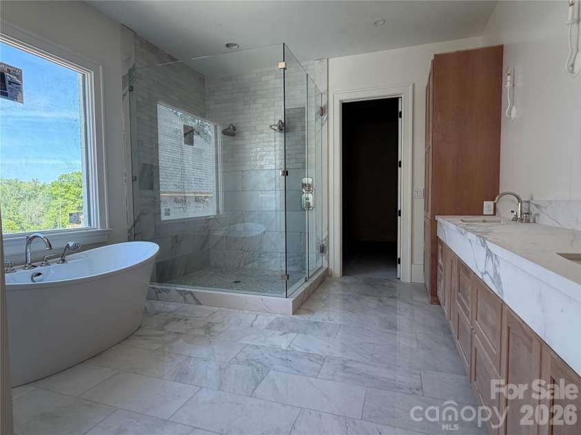 1430 Samuel Spencer Parkway, Davidson, NC 28036.  MLS# CAR4305336, YatesRealty ID 8. Spacious Primary Bathrrom with ready stackable washer/dryer  option in closet.