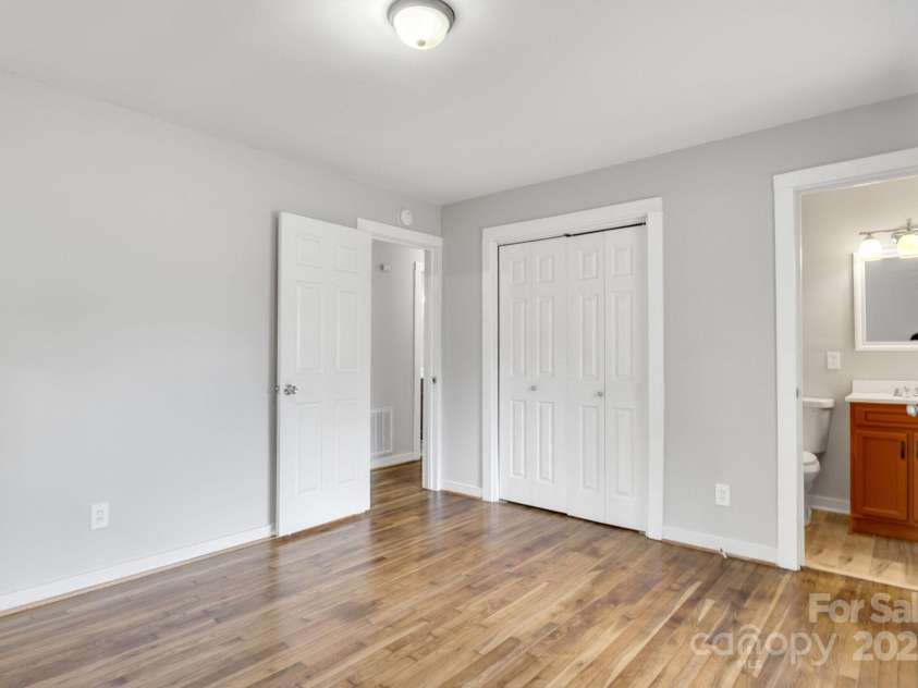 801 Bilmark Avenue, Charlotte, NC 28213.  MLS# CAR4247710, YatesRealty ID 8010. Primary bedroom facing entry door. There is a half bath on the right connected exclusively to the primary bedroom.