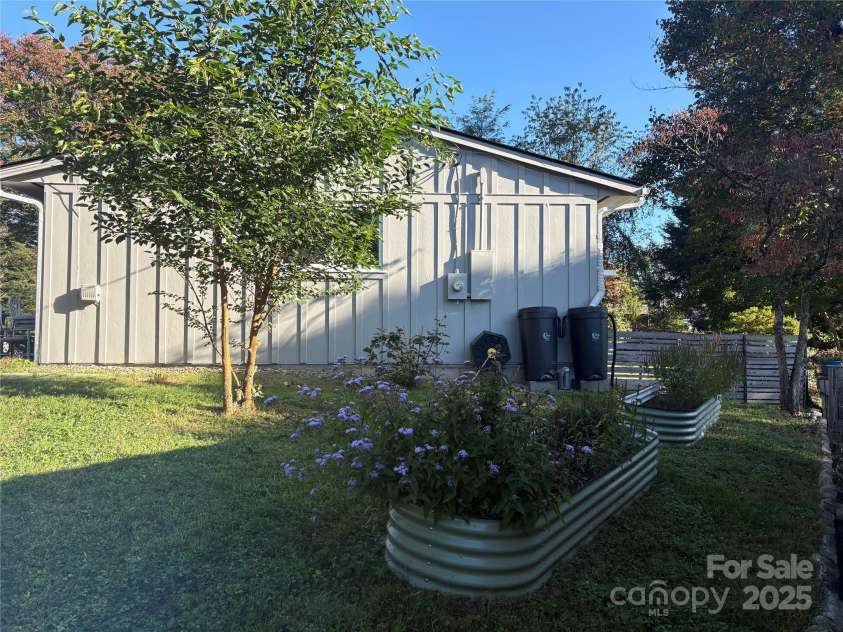 1235 Pinebrook Circle, Hendersonville, NC 28739.  MLS# CAR4309617, YatesRealty ID 8011. Side Yard with Raised Flower Beds 
