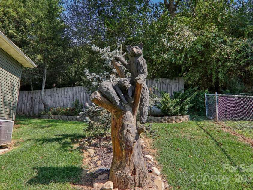 126 Pasco Loop, Waynesville, NC 28785.  MLS# CAR4301663, YatesRealty ID 8018. Carved bear art