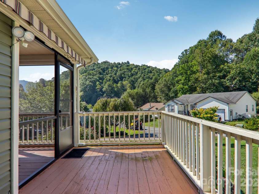 126 Pasco Loop, Waynesville, NC 28785.  MLS# CAR4301663, YatesRealty ID 8018. Side deck - motorized awnings for additional shade