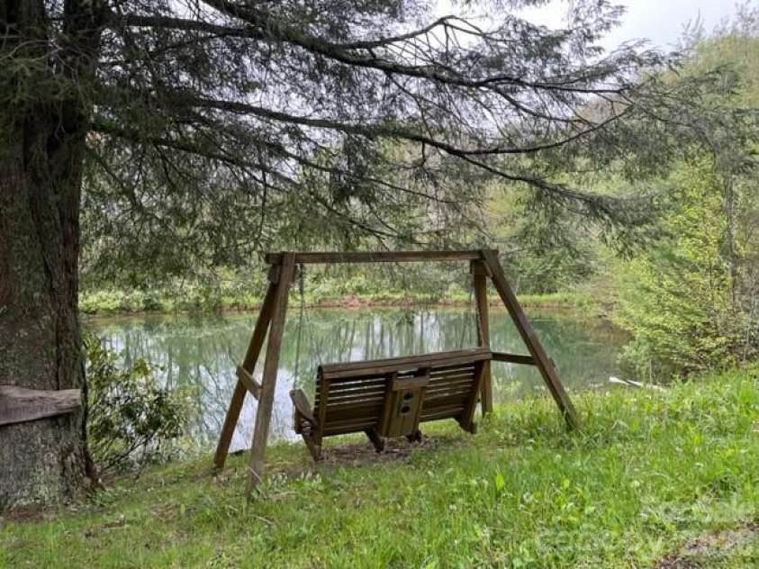 143 Daniel Boone Trail, Burnsville, NC 28714.  MLS# CAR4261449, YatesRealty ID 802. Community pond right down the road