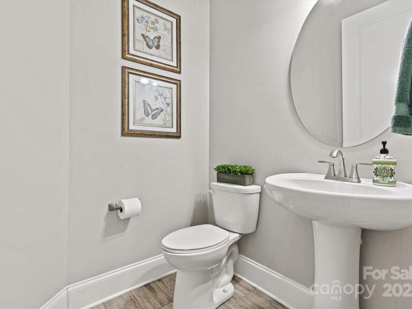 7549 Short Putt Court, Charlotte, NC 28215.  MLS# CAR4248938, YatesRealty ID 8028. A popular feature of the Hickory model is the Powder Room that is conveniently located for guests, ensuring easy access without interrupting the flow of the home.