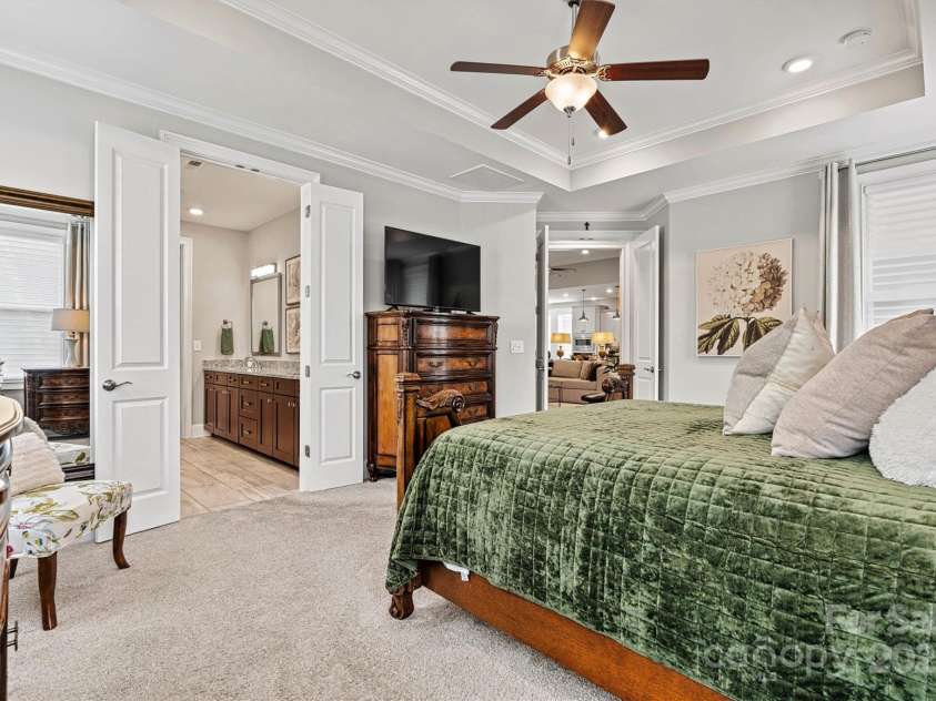 7549 Short Putt Court, Charlotte, NC 28215.  MLS# CAR4248938, YatesRealty ID 8028. Elegance and privacy combined! Solid French doors lead to the serene ensuite bath, just steps away from your peaceful Primary Suite retreat.