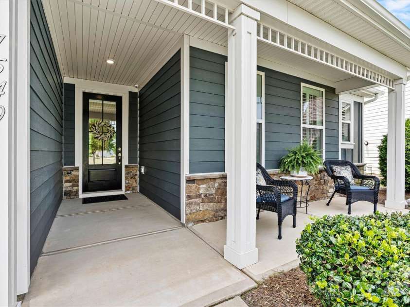 7549 Short Putt Court, Charlotte, NC 28215.  MLS# CAR4248938, YatesRealty ID 8028. From the covered porch to the stunning glass entry door, every step says ‘you’re going to love it here.