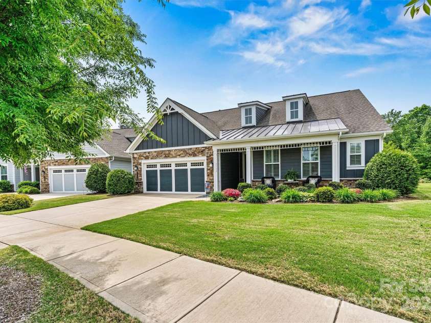 7549 Short Putt Court, Charlotte, NC 28215.  MLS# CAR4248938, YatesRealty ID 8028. Gorgeous upgraded landscaping pops in every season, perfectly paired with a lush, fully-sodded yard and in-ground irrigation with water from a community well. NO SEPARATE WATER BILL!