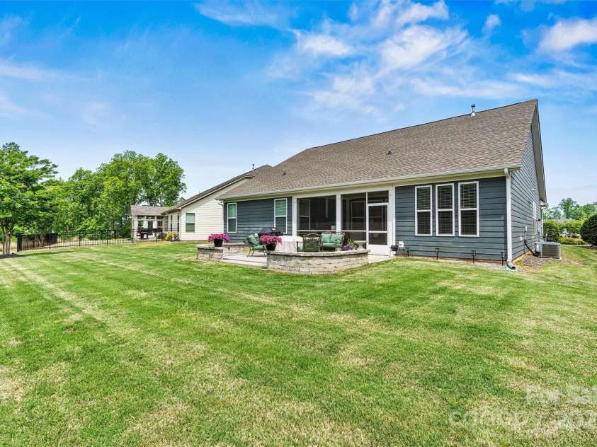 7549 Short Putt Court, Charlotte, NC 28215.  MLS# CAR4248938, YatesRealty ID 8028. More living, less mowing! The fully sodded yard with in-ground irrigation is maintained by the HOA—so you can spend your time doing what you really retired for!