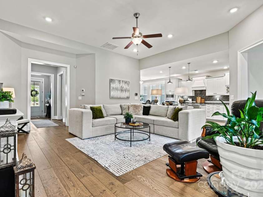 7549 Short Putt Court, Charlotte, NC 28215.  MLS# CAR4248938, YatesRealty ID 8028. Warmth and style meet in the Great Room! Rich wood floors, recessed lighting, custom paint, and a breezy ceiling fan make this space as inviting as it is impressive.