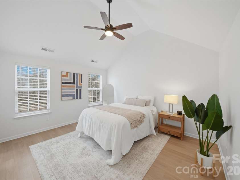 1494 Kindred Circle, Concord, NC 28027.  MLS# CAR4351536, YatesRealty ID 8040. 20 Spacious primary bedroom featuring a newly installed ceiling fan, new flooring and two windows, providing ample natural light.