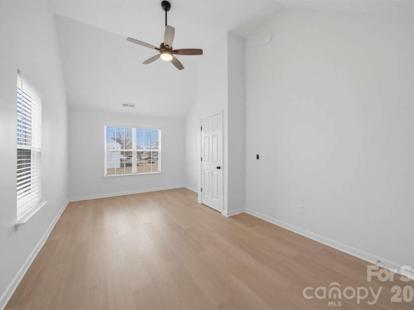 1494 Kindred Circle, Concord, NC 28027.  MLS# CAR4351536, YatesRealty ID 8040. 24 Second Bedroom features high ceilings, new flooring, a fan, and blinds.