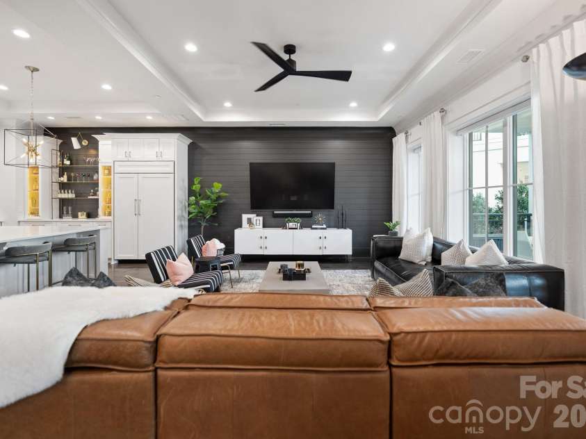 19329 Watermark Drive, Cornelius, NC 28031.  MLS# CAR4406294, YatesRealty ID 8051. Living room flows easily into the chef's kitchen with paneled SubZero refrigerator.