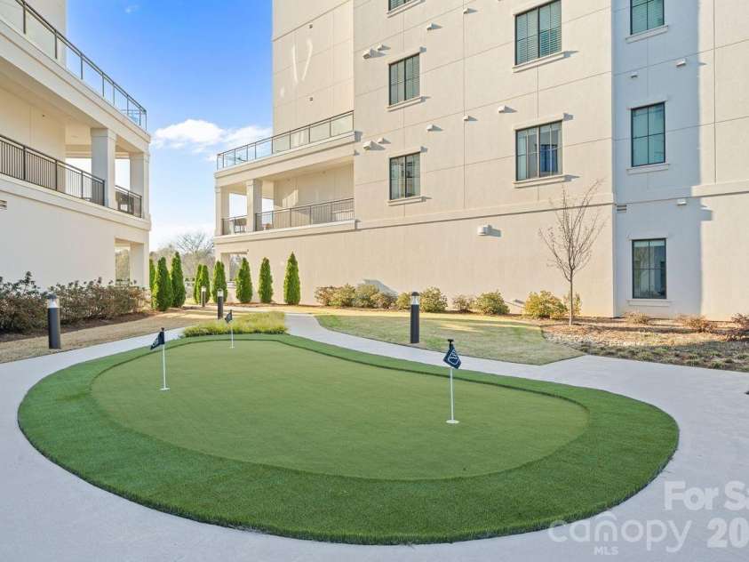 19329 Watermark Drive, Cornelius, NC 28031.  MLS# CAR4406294, YatesRealty ID 8051. Putting green on poolside level between 200 & 300