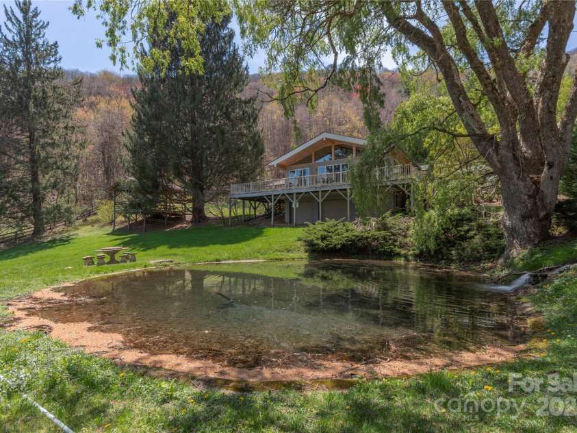 55 Grove Park, Waynesville, NC 28786.  MLS# CAR4218196, YatesRealty ID 8054. Front view of house with pond