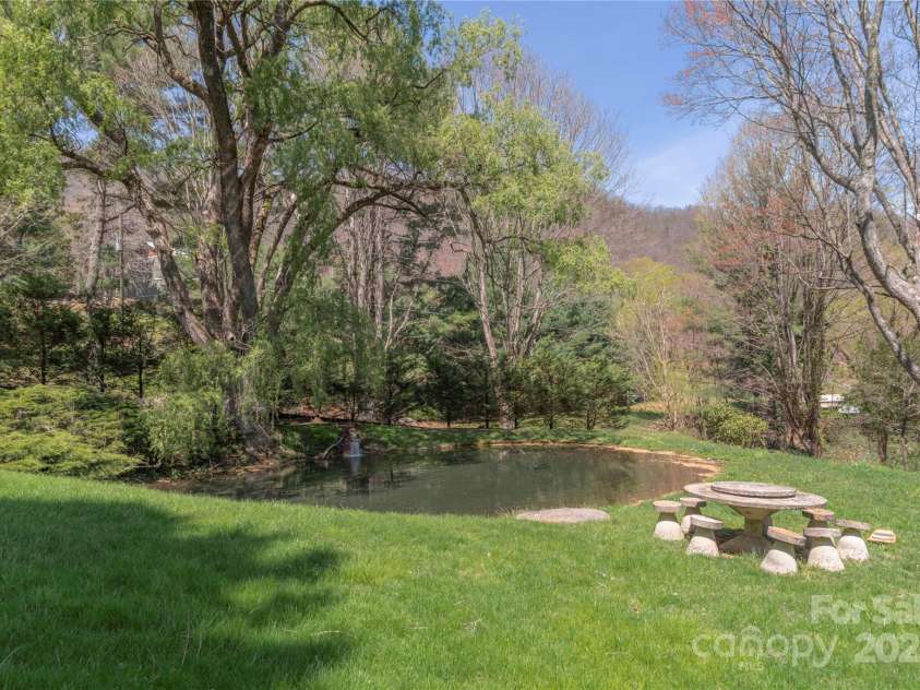 55 Grove Park, Waynesville, NC 28786.  MLS# CAR4218196, YatesRealty ID 8054. Front yard pond fed by creek