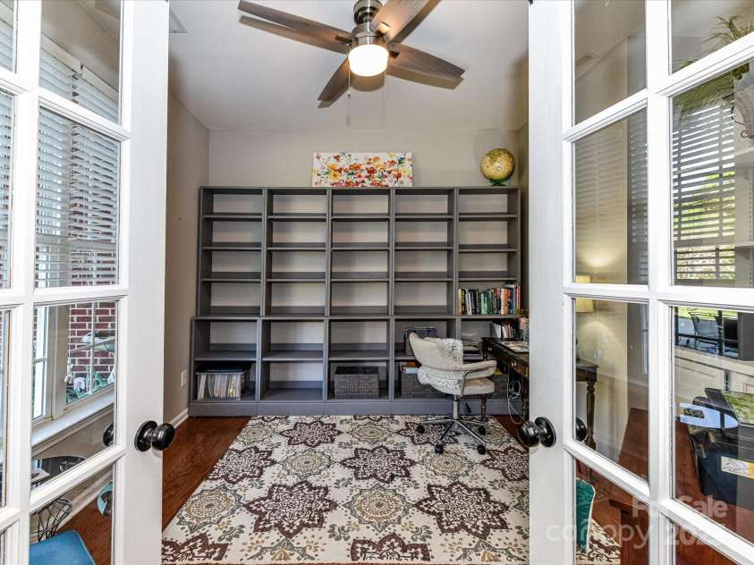 9427 Bethesda Court, Matthews, NC 28104.  MLS# CAR4243867, YatesRealty ID 8056. Office/Study on Main Level with french doors.  Book shelves are not attached and do not convey.