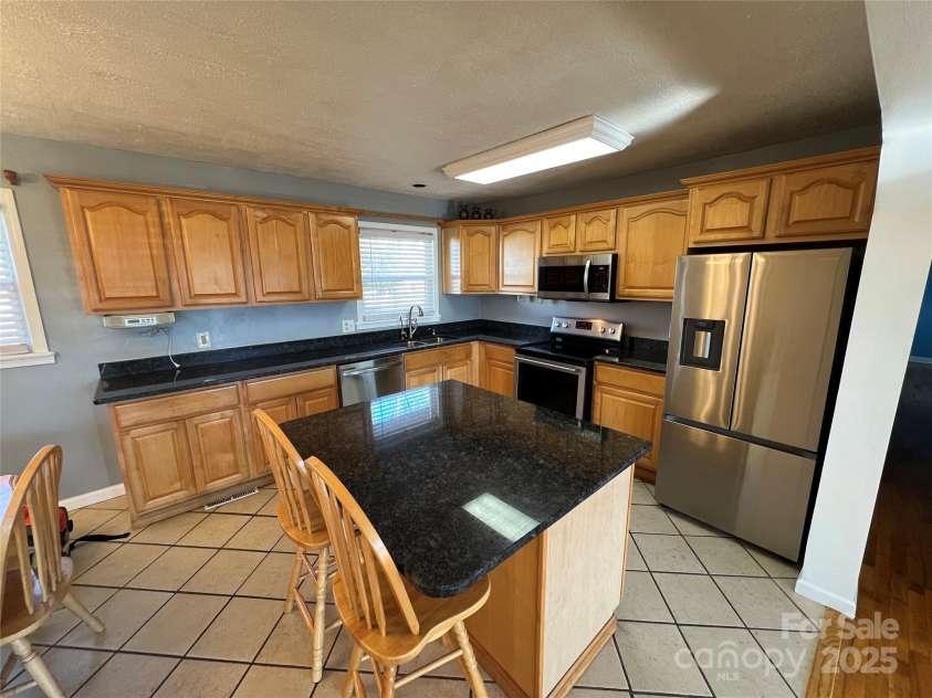604 Eastwood Drive, Albemarle, NC 28001.  MLS# CAR4210348, YatesRealty ID 8059. Kitchen with Island/Bar