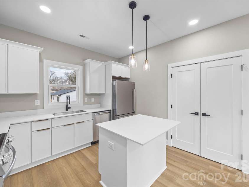 401 Lee Street, Mount Holly, NC 28120.  MLS# CAR4341029, YatesRealty ID 8060. Kitchen with double Door Pantry