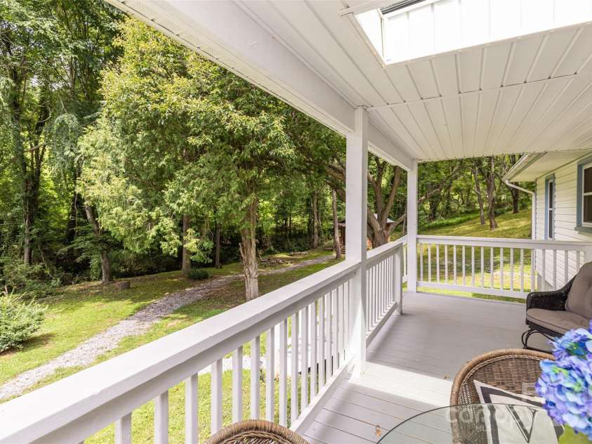 255 Chestnut Hill Road, Burnsville, NC 28714.  MLS# CAR4173831, YatesRealty ID 8073. Start your day on one of two inviting porches, listening to the soothing sounds of birdsong and a small creek.