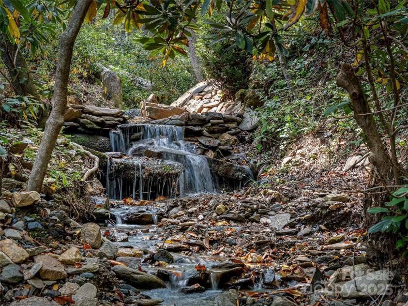 1299 Pine Ridge Road, Burnsville, NC 28714.  MLS# CAR4306270, YatesRealty ID 8091. Mountain stream located in the community (not on the property)