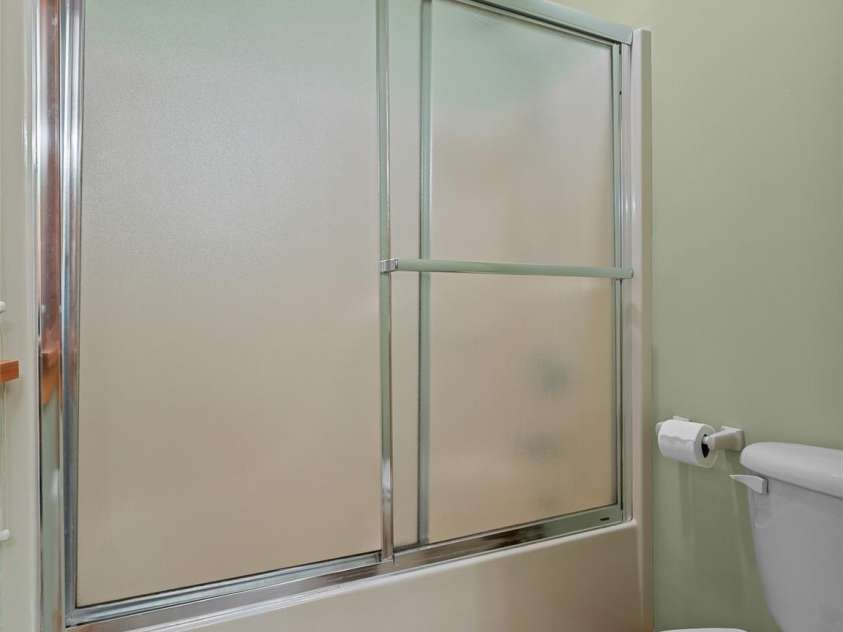 1299 Pine Ridge Road, Burnsville, NC 28714.  MLS# CAR4306270, YatesRealty ID 8091. Tub/shower and toilet separated by a pocket door