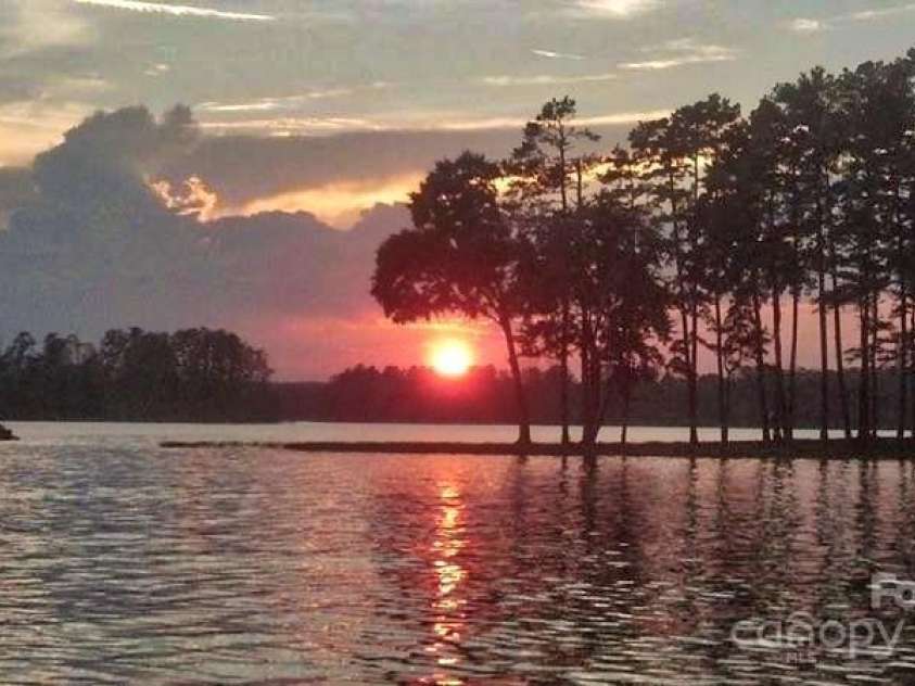 139 Sanford Lane, Badin Lake, NC 28127.  MLS# CAR4246223, YatesRealty ID 8117. Sunset on Badin Lake.