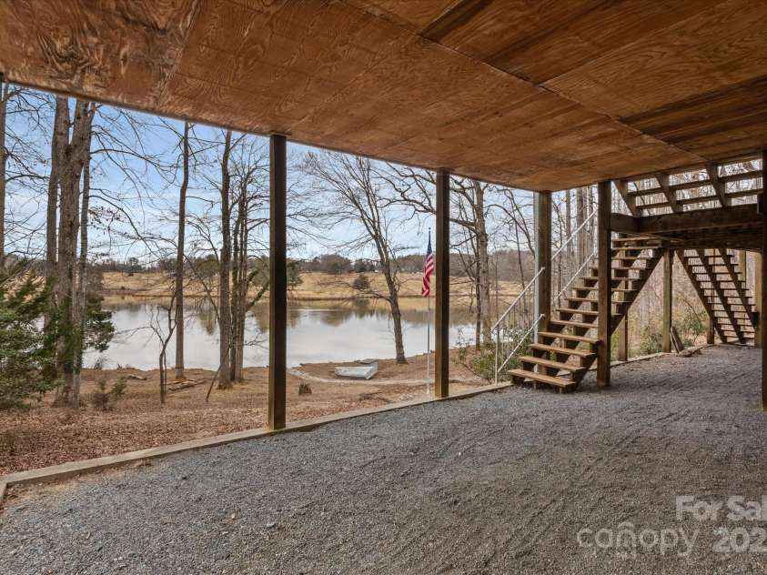 98 Fox Trail, Tryon, NC 28782.  MLS# CAR4232622, YatesRealty ID 8133. Golf cart driveway leads to golf cart garage in basement.