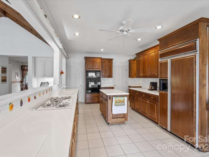 98 Fox Trail, Tryon, NC 28782.  MLS# CAR4232622, YatesRealty ID 8133. Kitchen is adjacent to half bath, laundry room, and garage.