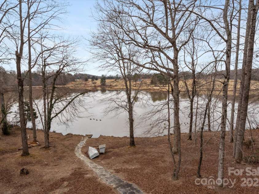 98 Fox Trail, Tryon, NC 28782.  MLS# CAR4232622, YatesRealty ID 8133. Overlooking the lake in the backyard.