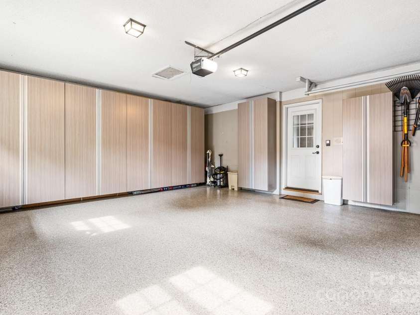 5486 Suttlemyre Lane, Hickory, NC 28601.  MLS# CAR4249269, YatesRealty ID 8145. Double garage on mail level right off the kitchen, built in's throughout the garage, work bench in the garage and updated painted speckle floors!!  What a man's paradise or a woman's storage delight!    You will love thi