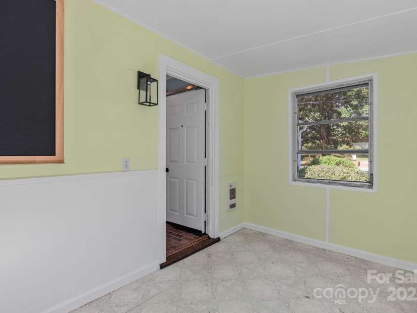 318 Stoney Mountain Road, Hendersonville, NC 28791.  MLS# CAR4235178, YatesRealty ID 8150. Back porch leads to the fenced back yard on one side and into the kitchen on the other.