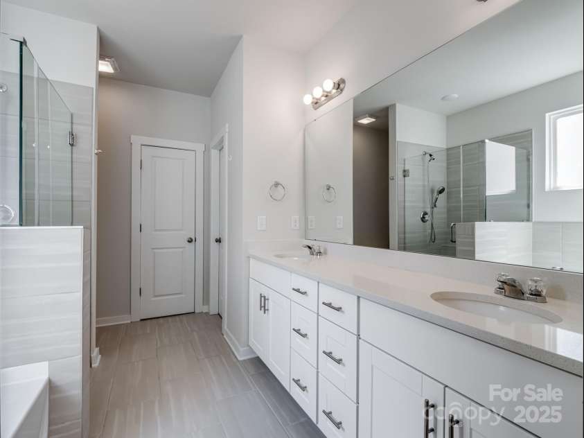 1045 Cavalier Lane, Rock Hill, SC 29730.  MLS# CAR4244737, YatesRealty ID 8160. Primary bathroom includes his and hers closets and large glass enclosed shower
