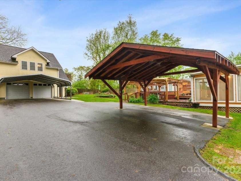 54 Fairview Street, Asheville, NC 28803.  MLS# CAR4237978, YatesRealty ID 8169. 2-bay garage with studio apartment and large carport.