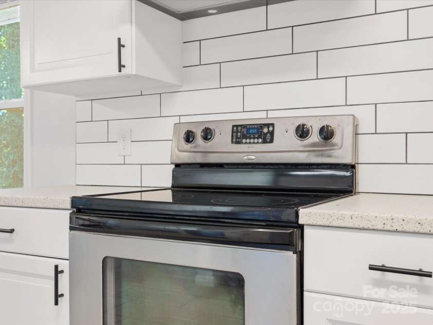724 Merridale Drive, Charlotte, NC 28214.  MLS# CAR4228503, YatesRealty ID 8170. Electric range with custom backsplash