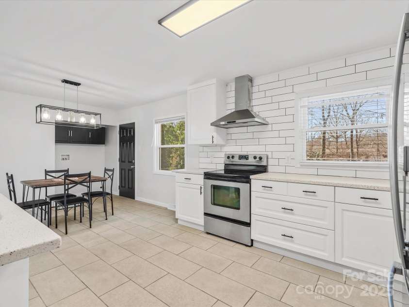 724 Merridale Drive, Charlotte, NC 28214.  MLS# CAR4228503, YatesRealty ID 8170. Open concept kitchen w/ tile floors & custom backsplash